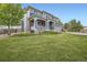 Beautifully landscaped front yard with a spacious lawn leading to a charming two-story home with inviting curb appeal at 7485 S Jackson Gap Way, Aurora, CO 80016