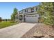 Lovely home with a two-car garage, covered porch, and well-maintained lawn and landscaping at 7485 S Jackson Gap Way, Aurora, CO 80016