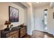 Stylish foyer with hardwood floors, a decorative dresser, and elegant decor for a welcoming entry at 7485 S Jackson Gap Way, Aurora, CO 80016