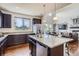 Modern kitchen featuring stainless steel appliances, an island with seating, and hardwood floors at 7485 S Jackson Gap Way, Aurora, CO 80016