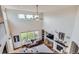 Bright living room with high ceilings, large windows, and a cozy fireplace. Overhead view at 7485 S Jackson Gap Way, Aurora, CO 80016