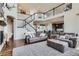 Open-concept living room with a staircase, abundant natural light, and a seamless flow to the kitchen at 7485 S Jackson Gap Way, Aurora, CO 80016