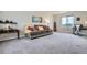 Spacious loft with plush carpeting, comfortable seating, and natural light from a large window at 7485 S Jackson Gap Way, Aurora, CO 80016