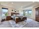Large main bedroom with tray ceiling, lots of natural light, and cozy carpet at 7485 S Jackson Gap Way, Aurora, CO 80016