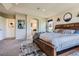 A stylish main bedroom with unique decor and a view of an ensuite bathroom at 7485 S Jackson Gap Way, Aurora, CO 80016