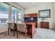Bright home office with a large desk, built-in shelving, and natural light at 7485 S Jackson Gap Way, Aurora, CO 80016