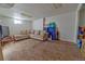 Finished basement area featuring carpeted floors, neutral walls, a comfortable sofa, and a television on a small stand at 8520 Franklin Dr, Denver, CO 80229