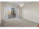 Spacious bedroom with carpet and sliding glass door to deck at 6000 W Floyd Ave # 105, Denver, CO 80227