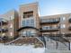 Modern apartment building exterior with a combination of siding and stone, showcasing multiple balconies at 6000 W Floyd Ave # 105, Denver, CO 80227