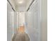 Hallway with multiple closets and access to bathroom at 6000 W Floyd Ave # 105, Denver, CO 80227