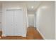 Hallway with hardwood floors and double door closet at 6000 W Floyd Ave # 105, Denver, CO 80227
