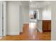 Inviting hallway with hardwood floors leading to an open-concept space with kitchen and view at 6000 W Floyd Ave # 105, Denver, CO 80227