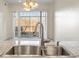 Stylish kitchen sink with stainless faucet overlooking the living area at 6000 W Floyd Ave # 105, Denver, CO 80227