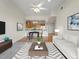Open living room features hardwood floors and kitchen with granite countertops at 6000 W Floyd Ave # 105, Denver, CO 80227