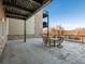 Covered patio with seating area and view of trees at 6000 W Floyd Ave # 105, Denver, CO 80227