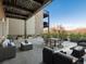 Spacious outdoor patio featuring comfortable seating, dining area, and a cozy fire pit at 6000 W Floyd Ave # 105, Denver, CO 80227