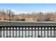 Open view of a quiet street and natural landscape at 6000 W Floyd Ave # 105, Denver, CO 80227