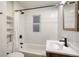 Modern bathroom featuring a shower over tub, decorative tile, and sleek fixtures at 1560 Clinton St, Aurora, CO 80010