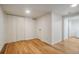 Bright bedroom with hardwood flooring, closet, and white walls, ready for your personal touch at 1560 Clinton St, Aurora, CO 80010