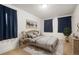 Comfortable bedroom with calm decor, a patterned rug, and natural light from multiple windows at 1560 Clinton St, Aurora, CO 80010