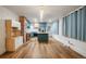 Open-concept kitchen featuring teal cabinetry, a central island, and modern appliances at 1560 Clinton St, Aurora, CO 80010