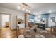 Well-lit kitchen features an island, modern appliances, and a breakfast nook with a charming brick accent wall at 1560 Clinton St, Aurora, CO 80010