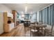 Open-concept kitchen featuring teal cabinetry, a central island, and modern appliances at 1560 Clinton St, Aurora, CO 80010