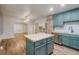 Bright kitchen with teal cabinets, butcher block countertops and a center island at 1560 Clinton St, Aurora, CO 80010