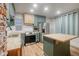 Stylish kitchen with butcher block countertops, stainless appliances and teal cabinets at 1560 Clinton St, Aurora, CO 80010