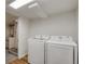 Laundry room with a new washer and dryer and easy access to the adjacent bathroom at 1560 Clinton St, Aurora, CO 80010