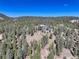 Gorgeous aerial view showcasing the secluded property surrounded by lush forest at 28154 Belle Mont Trl, Conifer, CO 80433