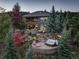 Aerial view of the backyard showing a hot tub, patio area, and verdant landscaping at 28154 Belle Mont Trl, Conifer, CO 80433