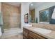 Well-lit bathroom showcasing a shower over tub with tile surround and vanity with ample storage at 28154 Belle Mont Trl, Conifer, CO 80433