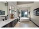 Spa-like bathroom features a soaking tub, dual sinks, and modern black and white accents at 28154 Belle Mont Trl, Conifer, CO 80433