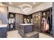 Spacious walk-in closet with custom cabinetry, shelving, and a center island at 28154 Belle Mont Trl, Conifer, CO 80433