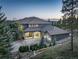 Stunning exterior elevation of a luxury home with porte-cochere and a circular driveway at 28154 Belle Mont Trl, Conifer, CO 80433