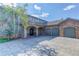 Charming front exterior of a beautiful home featuring a porte-cochere and three car garage at 28154 Belle Mont Trl, Conifer, CO 80433
