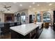Bright kitchen featuring large island, arched windows showcasing mountain views, and modern appliances at 28154 Belle Mont Trl, Conifer, CO 80433