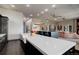 Open kitchen featuring a large island, stainless steel appliances, bar seating, and hardwood floors at 28154 Belle Mont Trl, Conifer, CO 80433