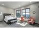 Bright main bedroom with seating area, luxury upholstered bed, and mountain views at 28154 Belle Mont Trl, Conifer, CO 80433
