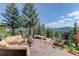 Outdoor patio area featuring comfortable seating, fire pit, and hot tub at 28154 Belle Mont Trl, Conifer, CO 80433