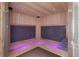 Custom sauna with ambient lighting, wooden benches, and infrared heating panels at 28154 Belle Mont Trl, Conifer, CO 80433