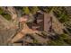 Aerial view of a house with a brown roof, surrounded by lush greenery and a driveway at 278 Snowshoe Cir, Breckenridge, CO 80424