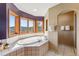 Bathroom with a soaking tub with mountain views from windows and a walk-in shower at 278 Snowshoe Cir, Breckenridge, CO 80424