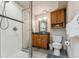 Clean bathroom with a glass-enclosed shower, a wooden vanity, and a toilet at 278 Snowshoe Cir, Breckenridge, CO 80424