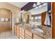 Bathroom with a double sink vanity with granite countertop, tub with windows, and a walk-in shower at 278 Snowshoe Cir, Breckenridge, CO 80424