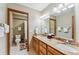 Bathroom with double sink vanity, granite countertops, wood cabinets, and walk-in shower at 278 Snowshoe Cir, Breckenridge, CO 80424