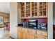 Butler pantry with wooden cabinetry, granite countertop, and a TV for added convenience at 278 Snowshoe Cir, Breckenridge, CO 80424