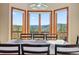 Dining area with bay windows offering scenic views of the surrounding nature at 278 Snowshoe Cir, Breckenridge, CO 80424