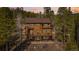 Stunning two-story home with a large deck, surrounded by lush greenery and scenic mountain views at 278 Snowshoe Cir, Breckenridge, CO 80424